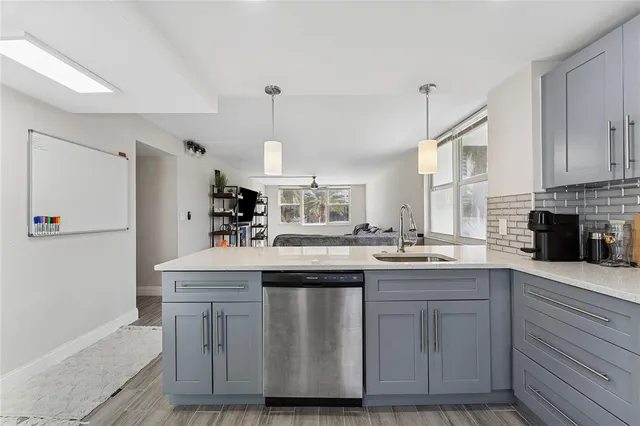 a kitchen with a stove a sink and cabinets