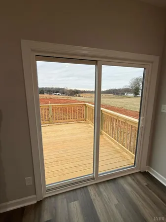 a large kitchen with a lot of cabinets and wooden floor