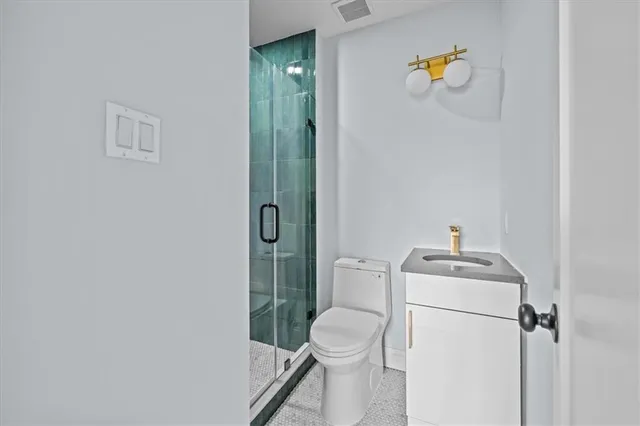 a white toilet sitting next to a bathroom sink