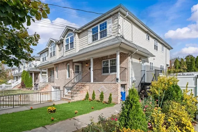 a front view of a house with a garden
