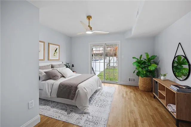 a living room with a bed furniture and a flat screen tv