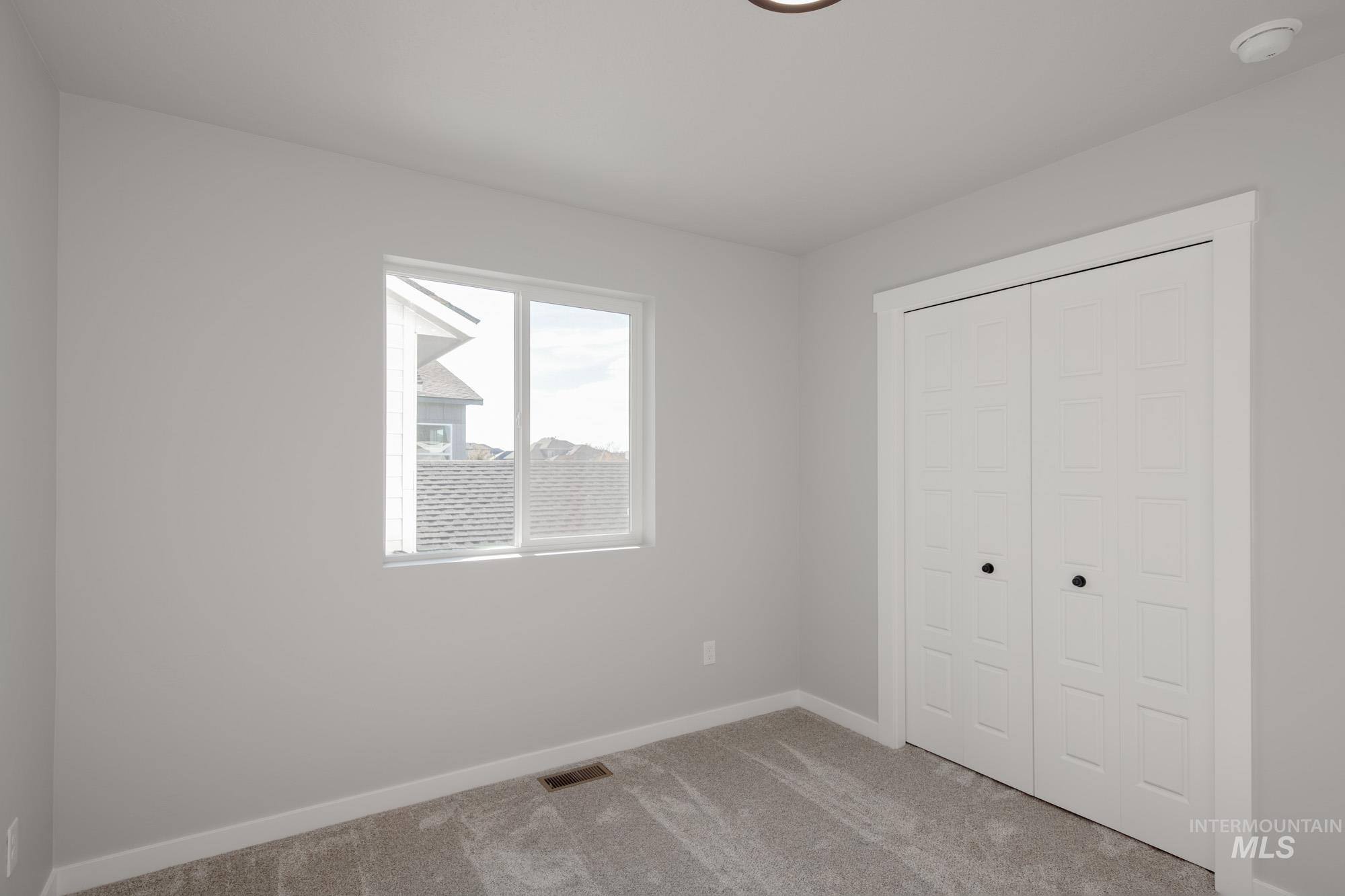 2058 South Border Way Meridian, ID 83642 - Photo 23 of 25 Unfurnished bedroom with light colored carpet and a closet