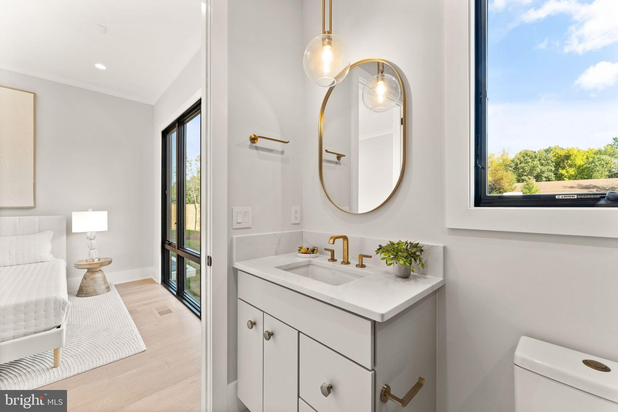 917 Timber Lane Southwest Vienna, VA 22180 - Photo 15 of 41 a en suite bathroom with a double vanity sink and a mirror