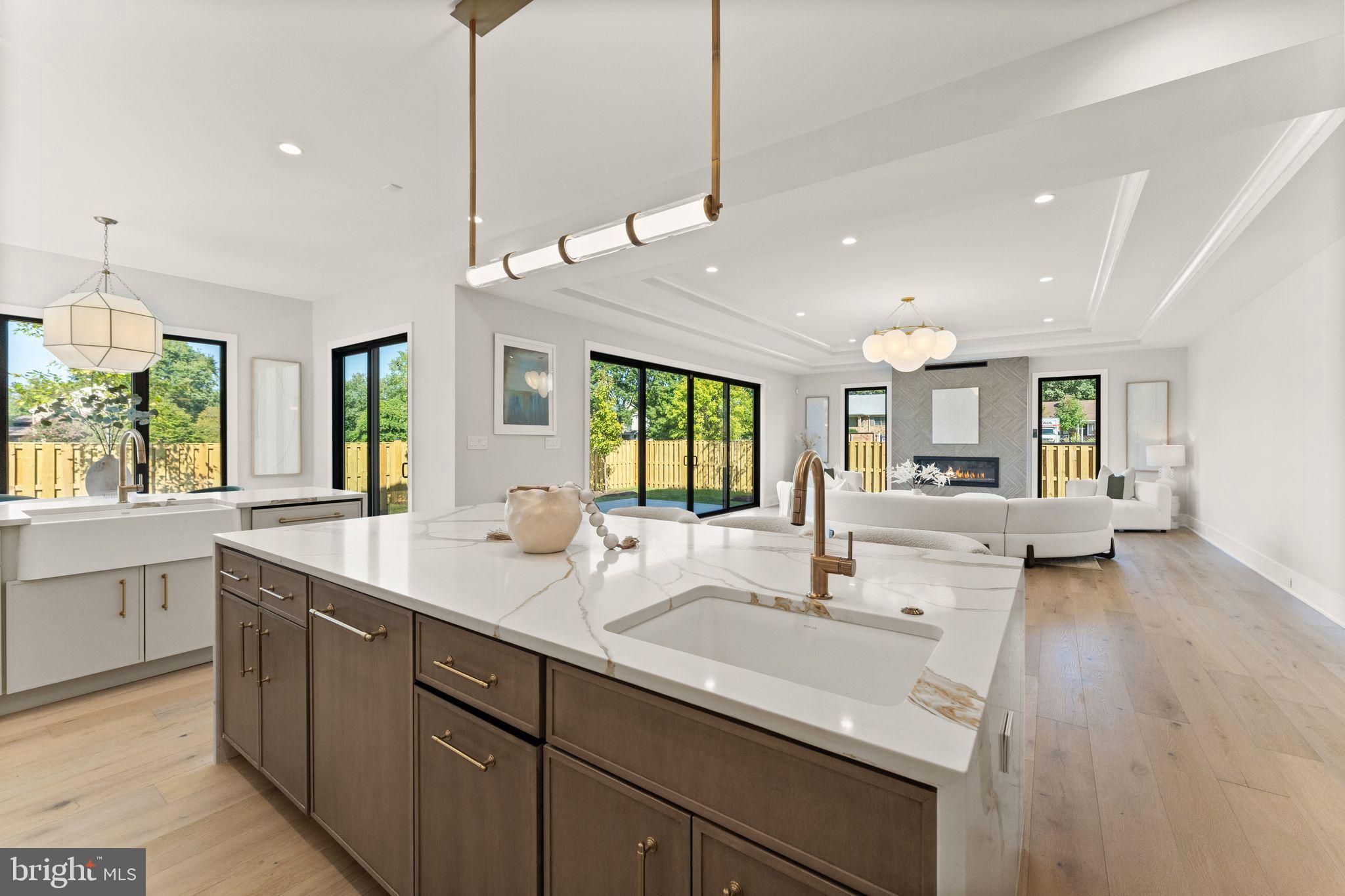 917 Timber Lane Southwest Vienna, VA 22180 - Photo 2 of 41 a kitchen with sink stove and white cabinets with wooden floor