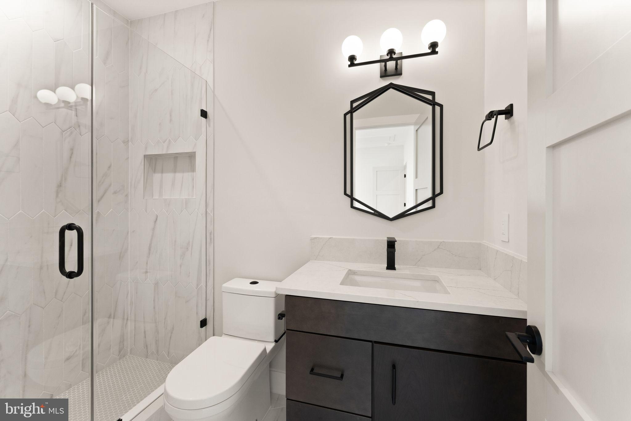 917 Timber Lane Southwest Vienna, VA 22180 - Photo 32 of 41 a bathroom with a sink toilet and shower