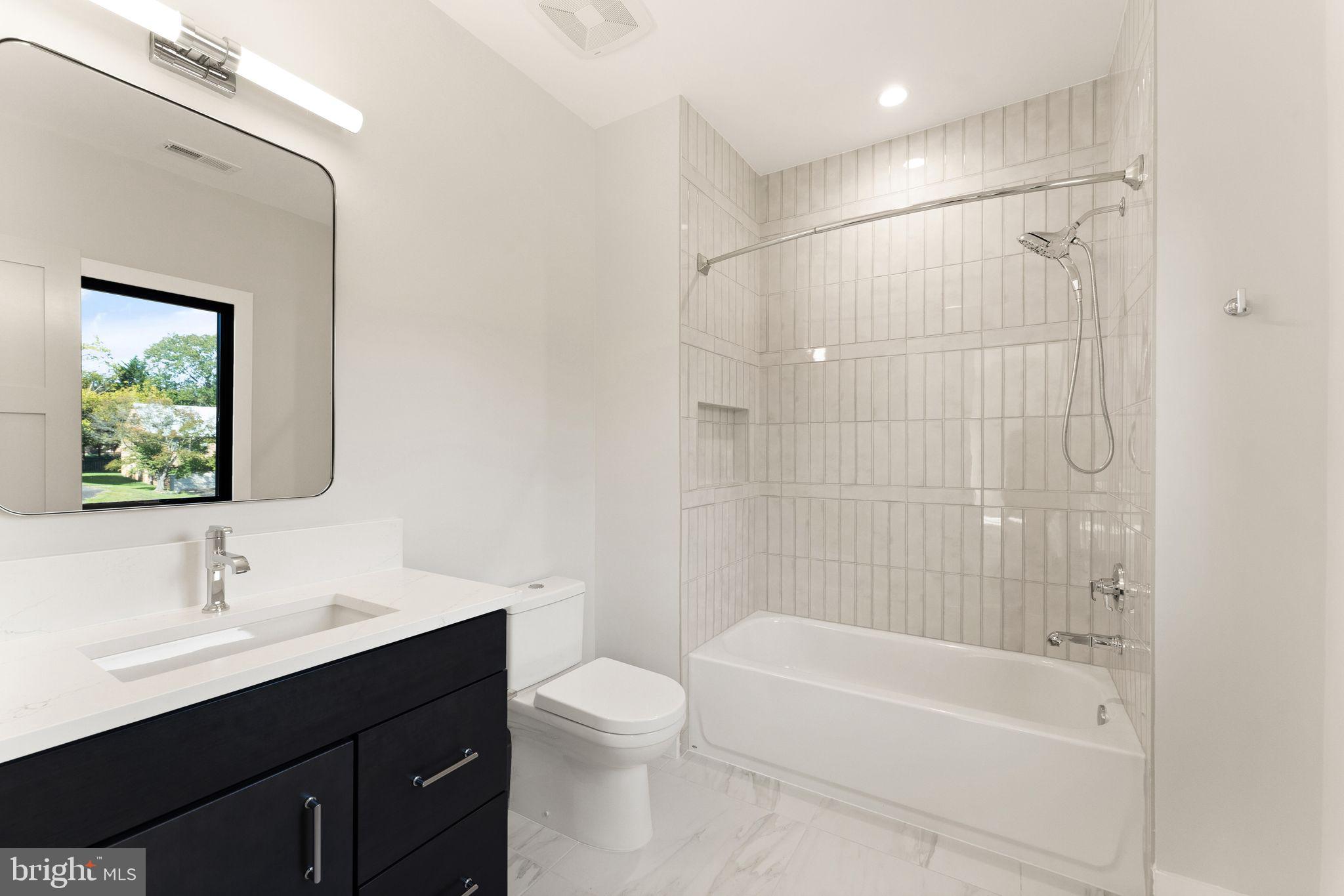 917 Timber Lane Southwest Vienna, VA 22180 - Photo 35 of 41 a bathroom with a bathtub shower sink vanity mirror and toilet