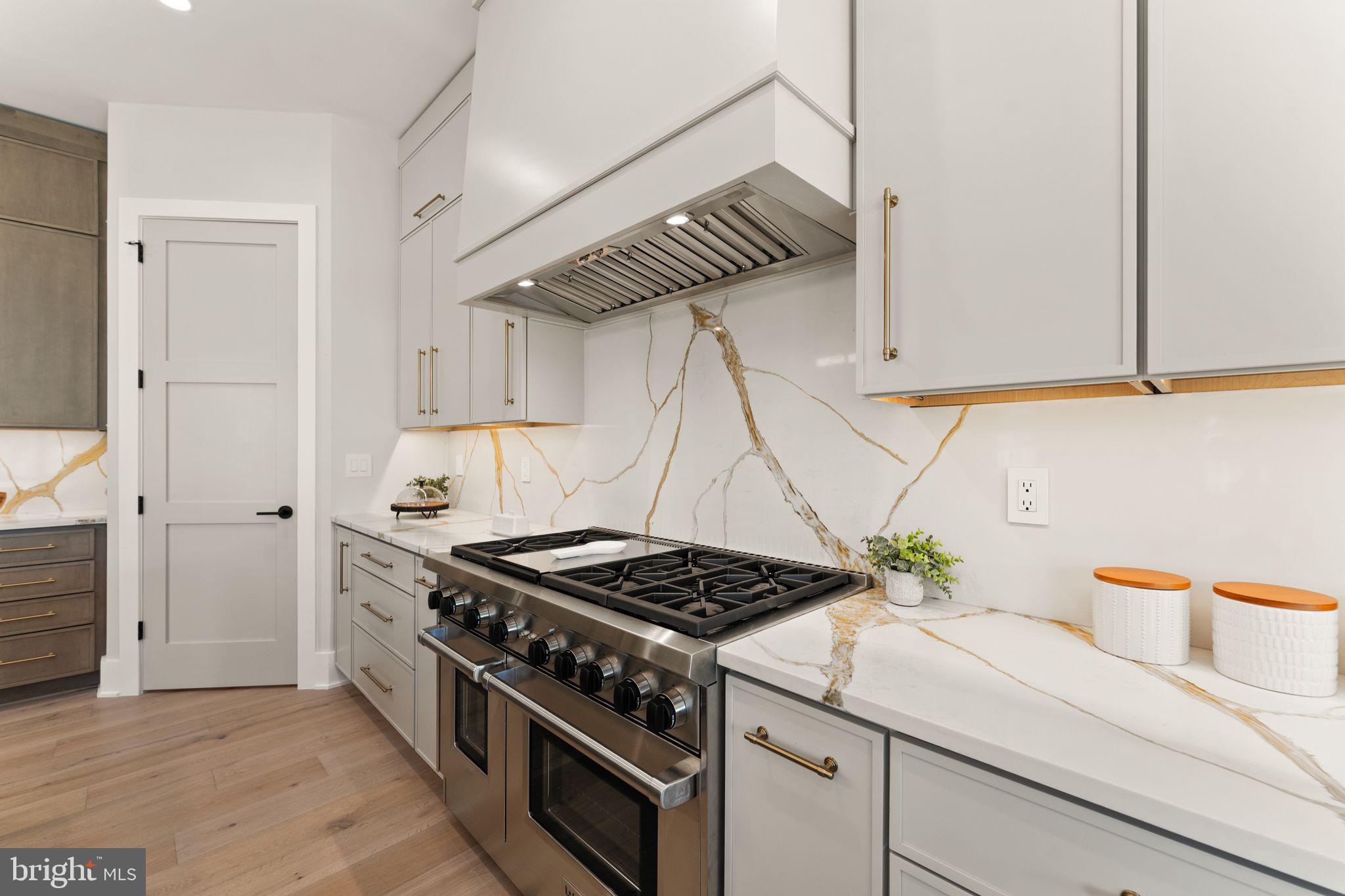 917 Timber Lane Southwest Vienna, VA 22180 - Photo 5 of 41 a kitchen with stainless steel appliances a stove a white cabinets and a sink