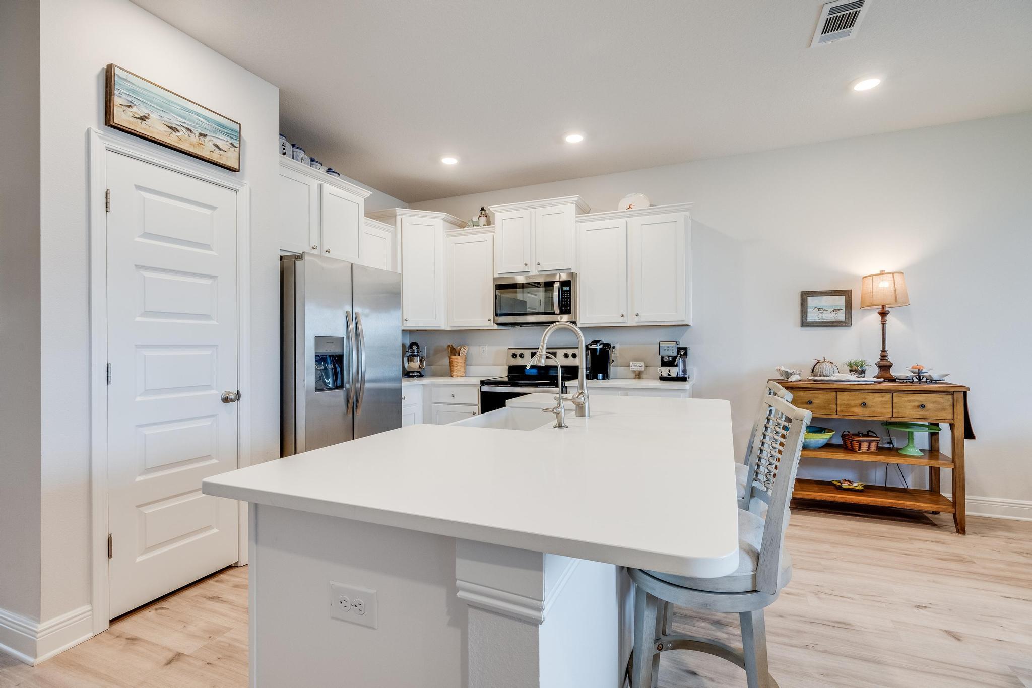 5 Redbird Loop Destin, FL 32541 - Photo 9 of 24 a large kitchen with a table and chairs