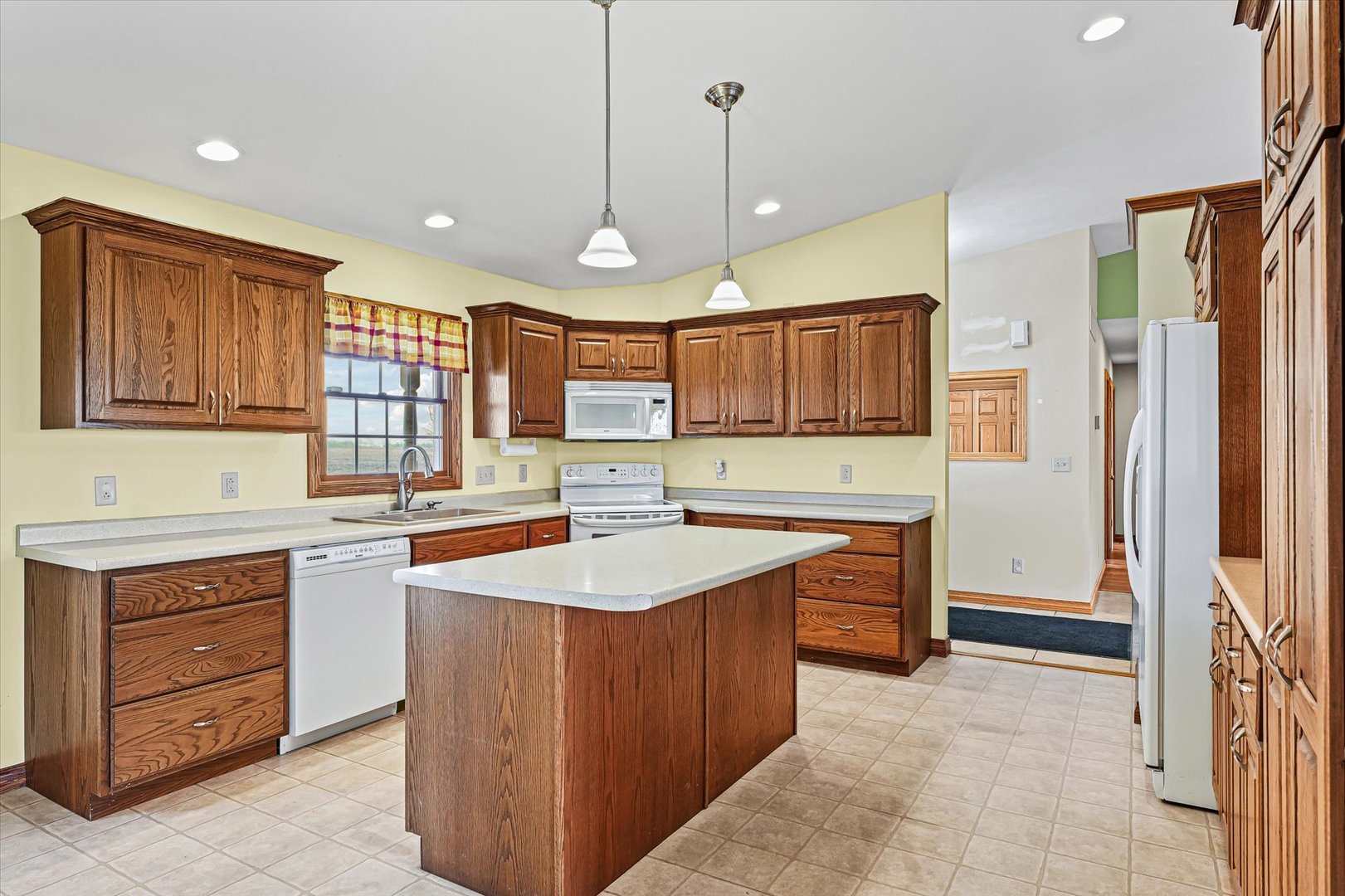 8735 North 2000 E Road Fairbury, IL 61739 - Photo 11 of 64 a kitchen with a stove sink and refrigerator