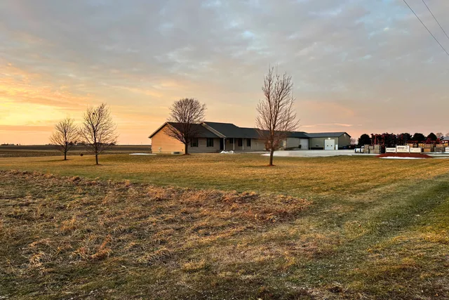 a view of a hallway with wooden floor and closet