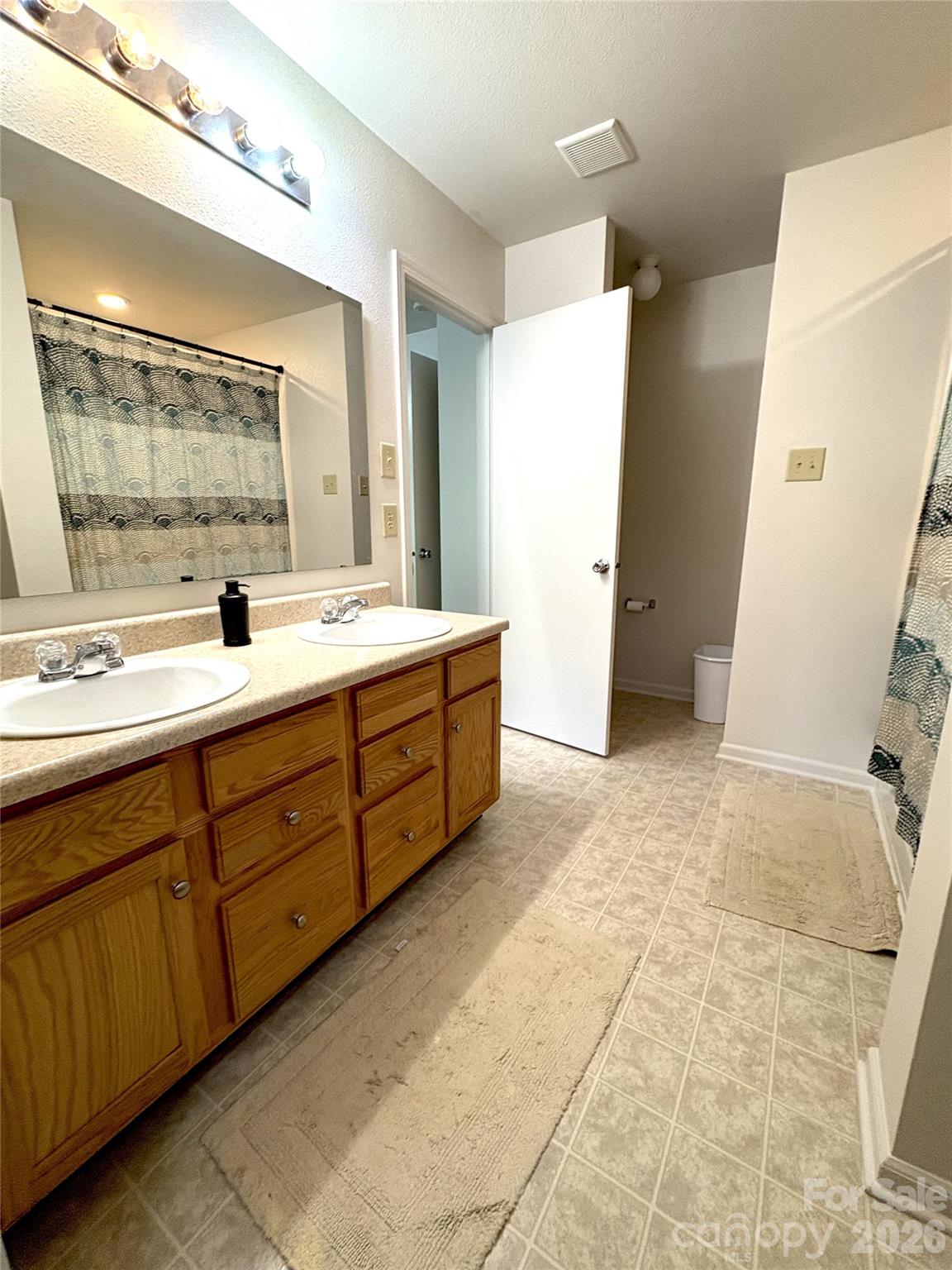 2514 Spring Breeze Way Monroe, NC 28110 - Photo 17 of 25 a bathroom with a double vanity sink mirror double and shower