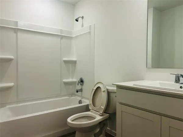 a bathroom with a sink mirror toilet and bathtub