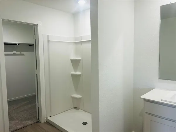 a bathroom with a granite countertop toilet and a sink