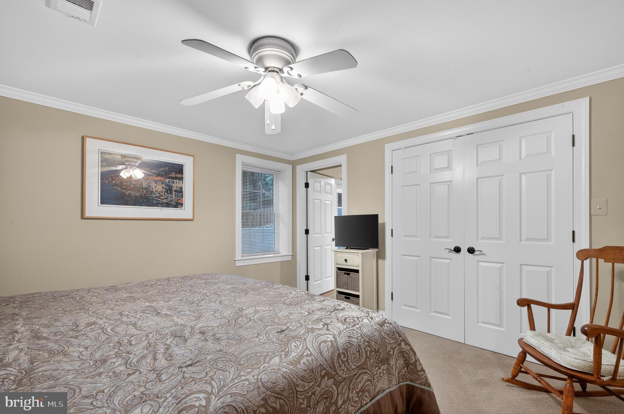 6601 Colchester Road Fairfax Station, VA 22039 - Photo 54 of 78 a bedroom with a bed and a chandelier