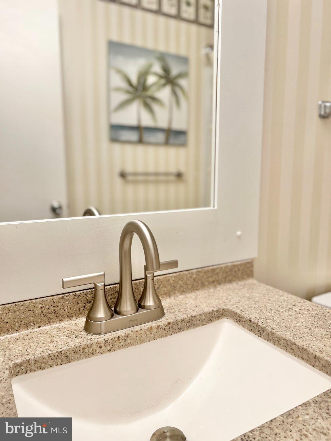 119 Old Landing Road, Unit 102F5 Ocean City, MD 21842 - Photo 8 of 19 Sleek bathroom oasis with coastal charm.