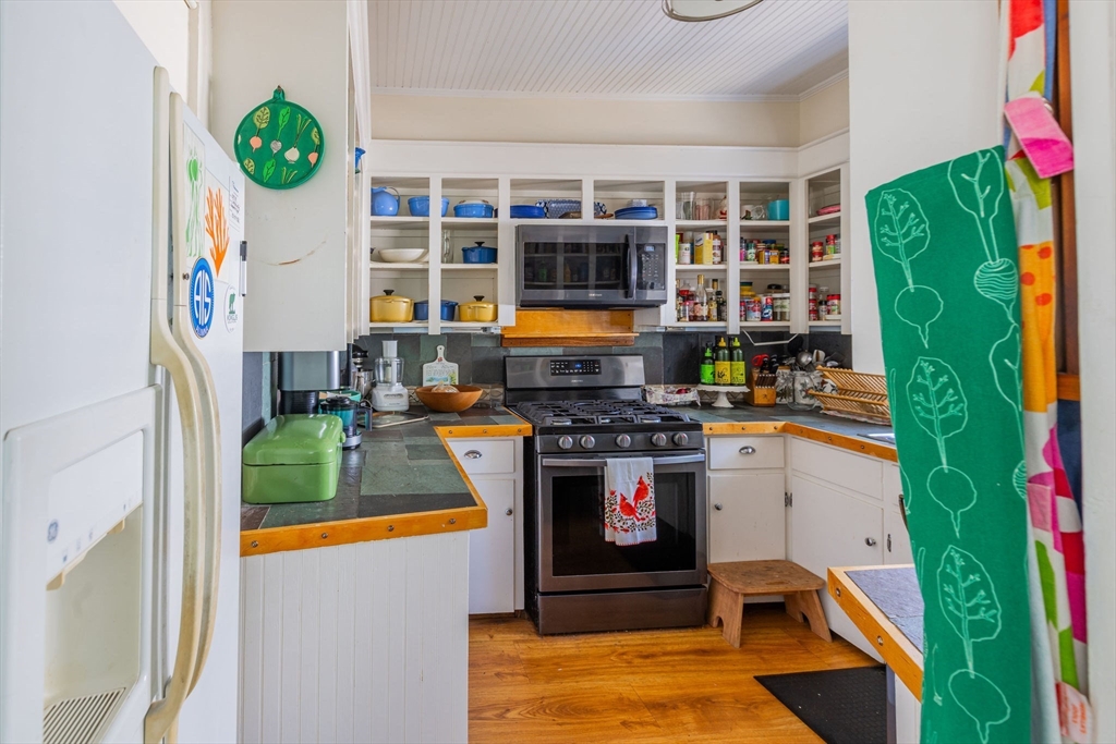 27 Maverick Street Marblehead, MA 01945 - Photo 16 of 31 a kitchen with stainless steel appliances granite countertop a stove and a refrigerator