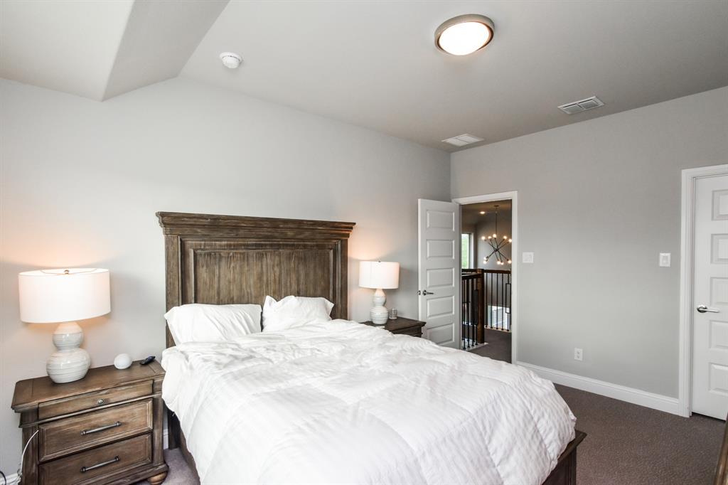 2516 Maidenhair Road Frisco, TX 75033 - Photo 24 of 30 a large bedroom with a bed and a lamp on table