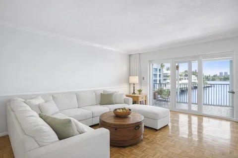 a living room with furniture and a floor to ceiling window
