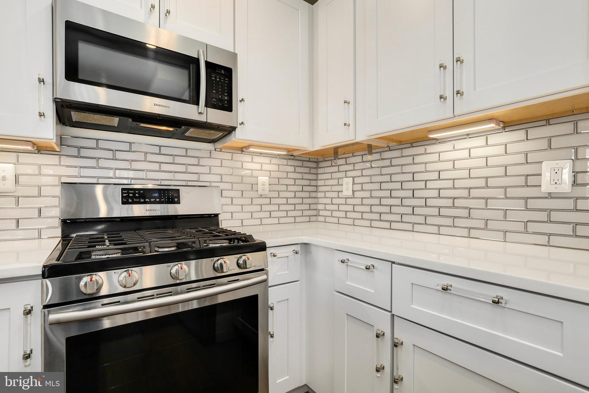 5629 8th Street Northwest Washington, DC 20011 - Photo 12 of 42 a kitchen with microwave stove and cabinets