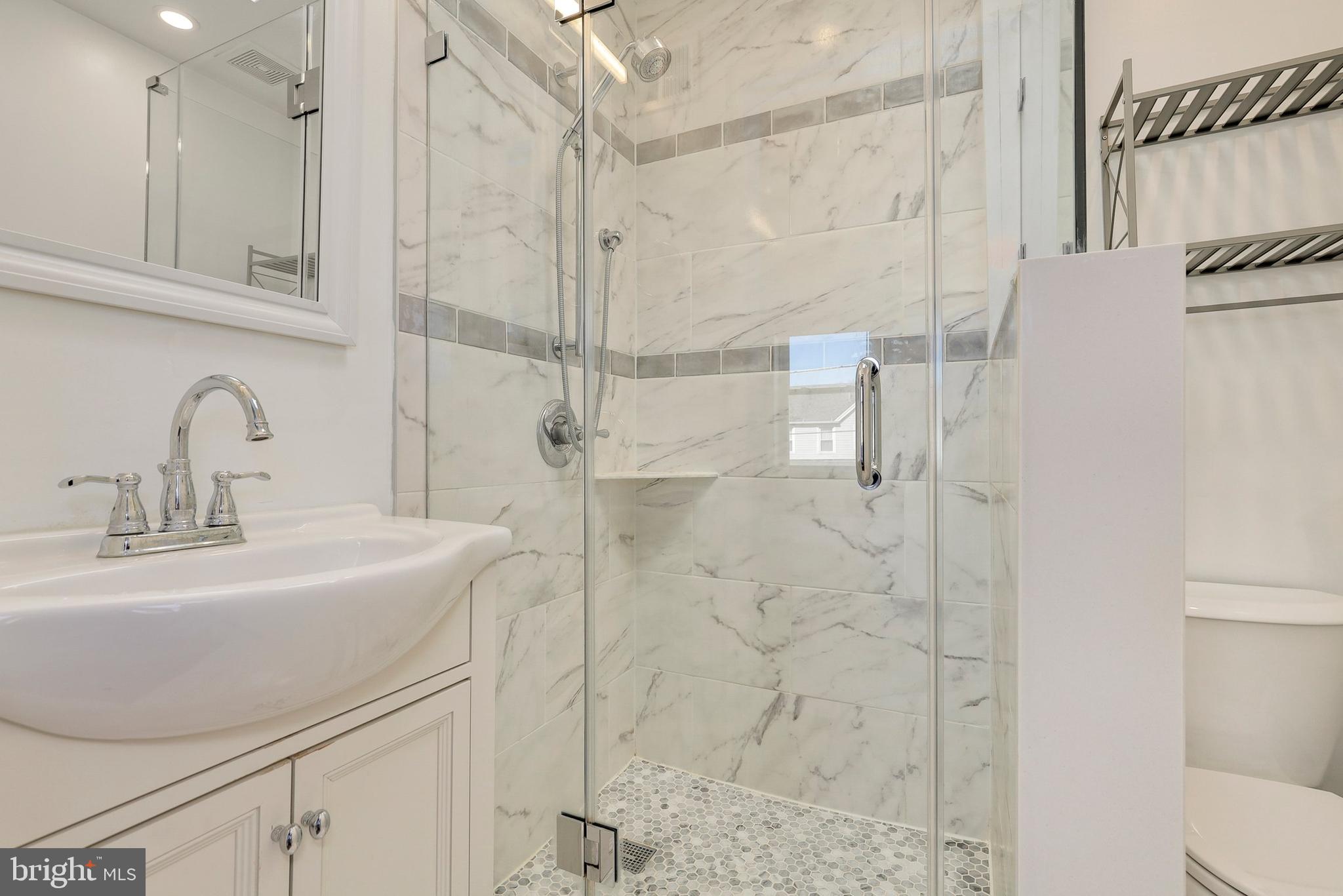 5629 8th Street Northwest Washington, DC 20011 - Photo 21 of 42 a bathroom with a sink shower and a mirror