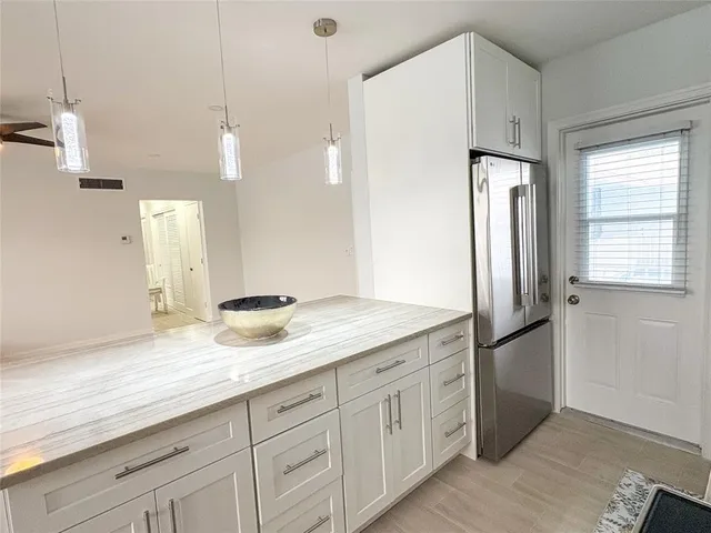 a kitchen with stainless steel appliances kitchen island hardwood floor sink and stove