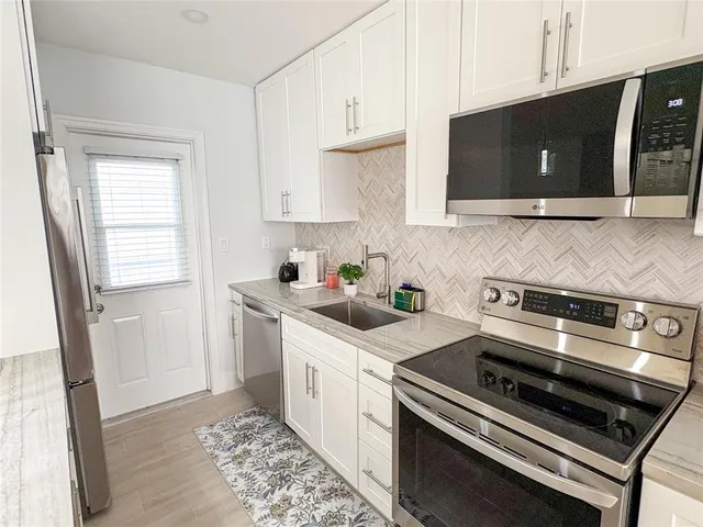 a kitchen with a sink stove and microwave