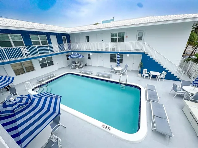 a kitchen with stainless steel appliances kitchen island granite countertop a stove a sink and a microwave