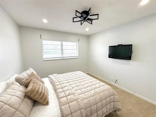 a room with a bed and a flat screen tv