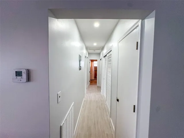 a spacious bedroom with a large bed and a large window