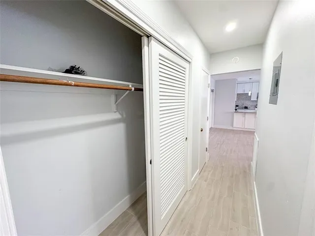 a kitchen with stainless steel appliances granite countertop a sink a stove a refrigerator a counter top space and cabinets