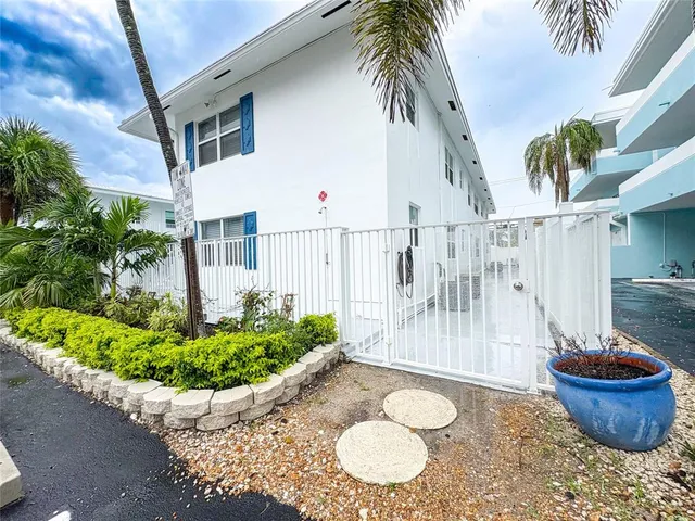 a dining room with furniture and a potted plant