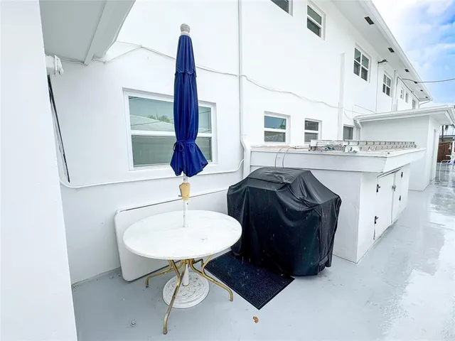 a view of a house with a yard and potted plants