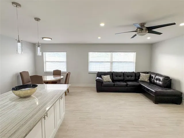 a bedroom with a bed and a ceiling fan