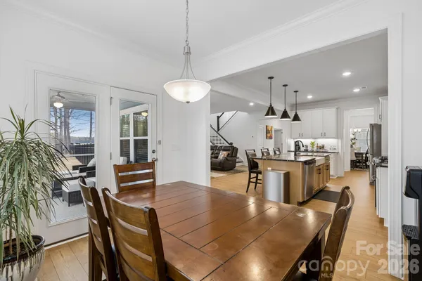 a kitchen with a table chairs refrigerator and stove