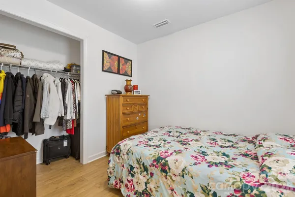 a bedroom with a bed and a closet