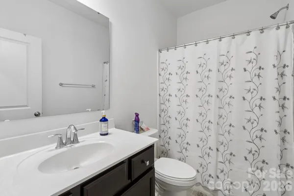 a bathroom with a sink toilet and a mirror