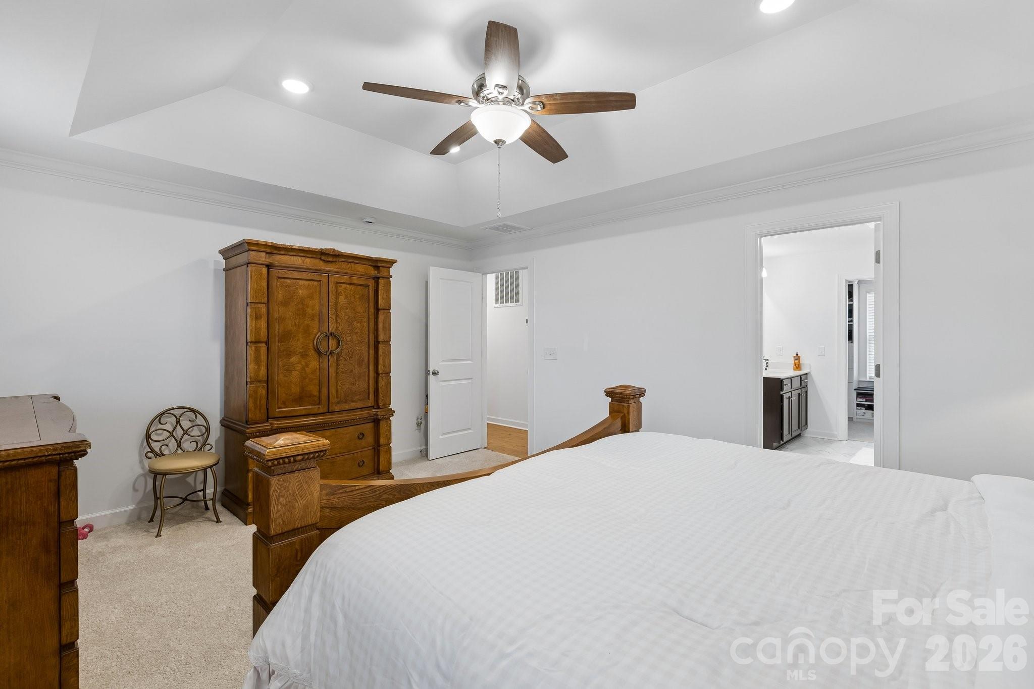 911 Cypress Point Lane Monroe, NC 28112 - Photo 19 of 37 a bedroom with a bed and a chandelier