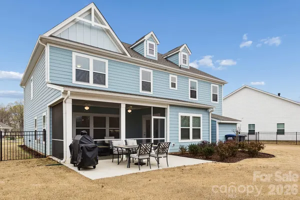 a front view of a house with outdoor seating and barbeque oven