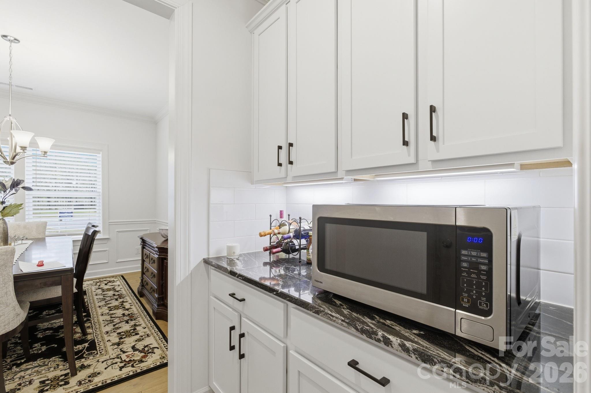 911 Cypress Point Lane Monroe, NC 28112 - Photo 6 of 37 a kitchen with granite countertop white cabinets and white appliances