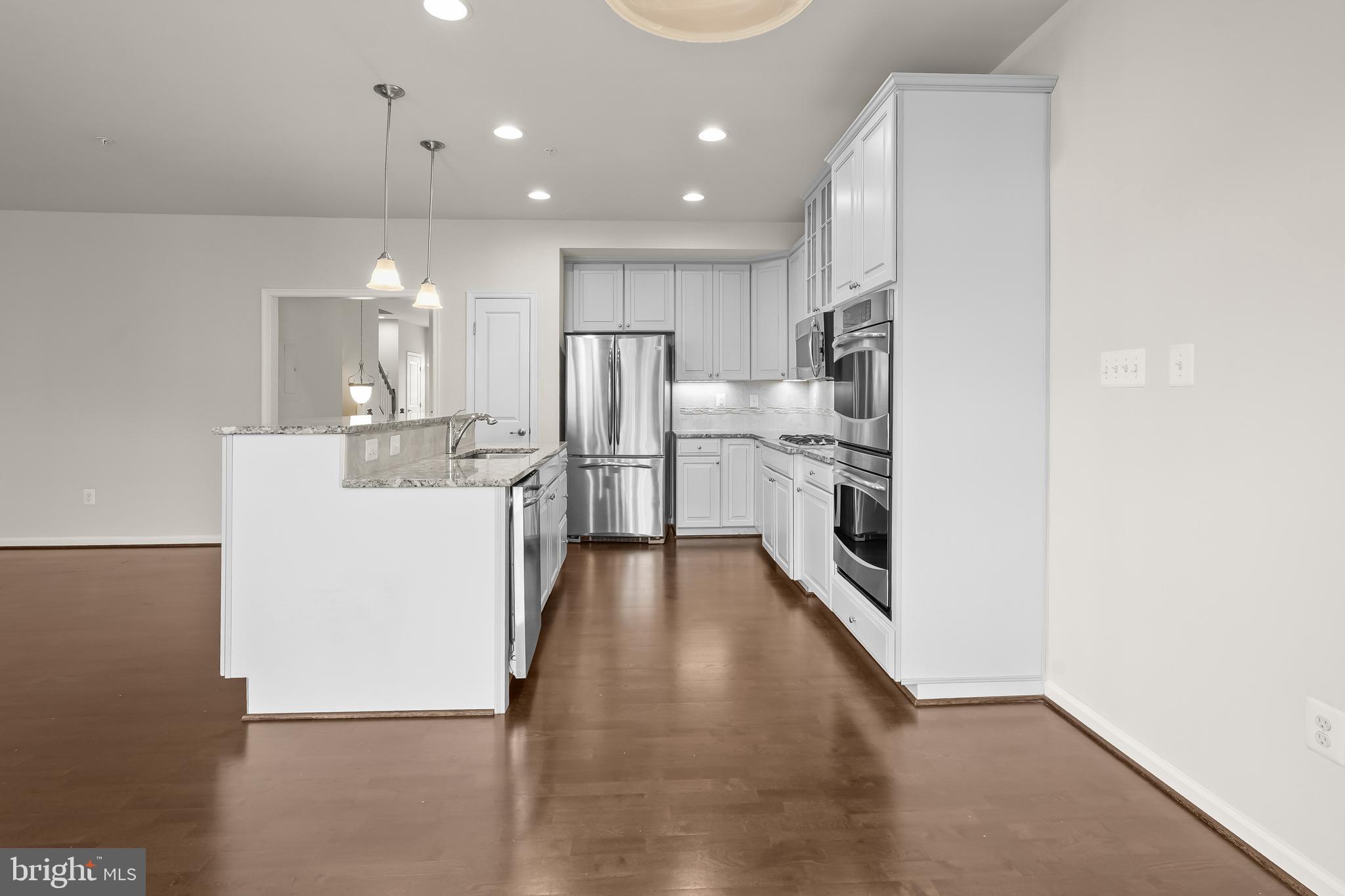 336 Chessington Drive Odenton, MD 21113 - Photo 5 of 24 a kitchen with stainless steel appliances a refrigerator and a stove top oven