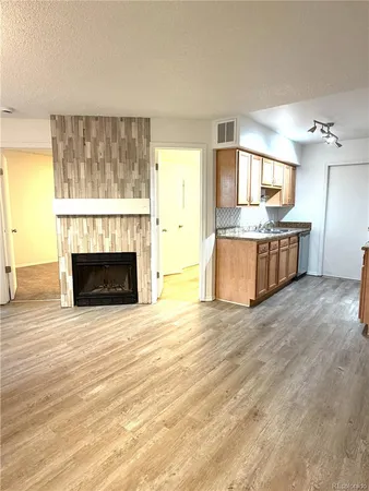 a view of a kitchen with a stove cabinets and a fireplace