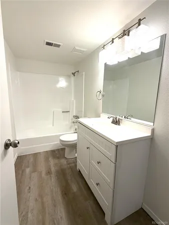 a bathroom with a double vanity sink mirror and toilet