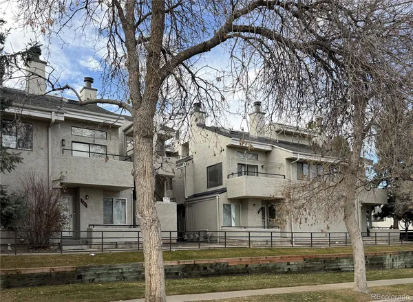 a front view of residential houses with yard