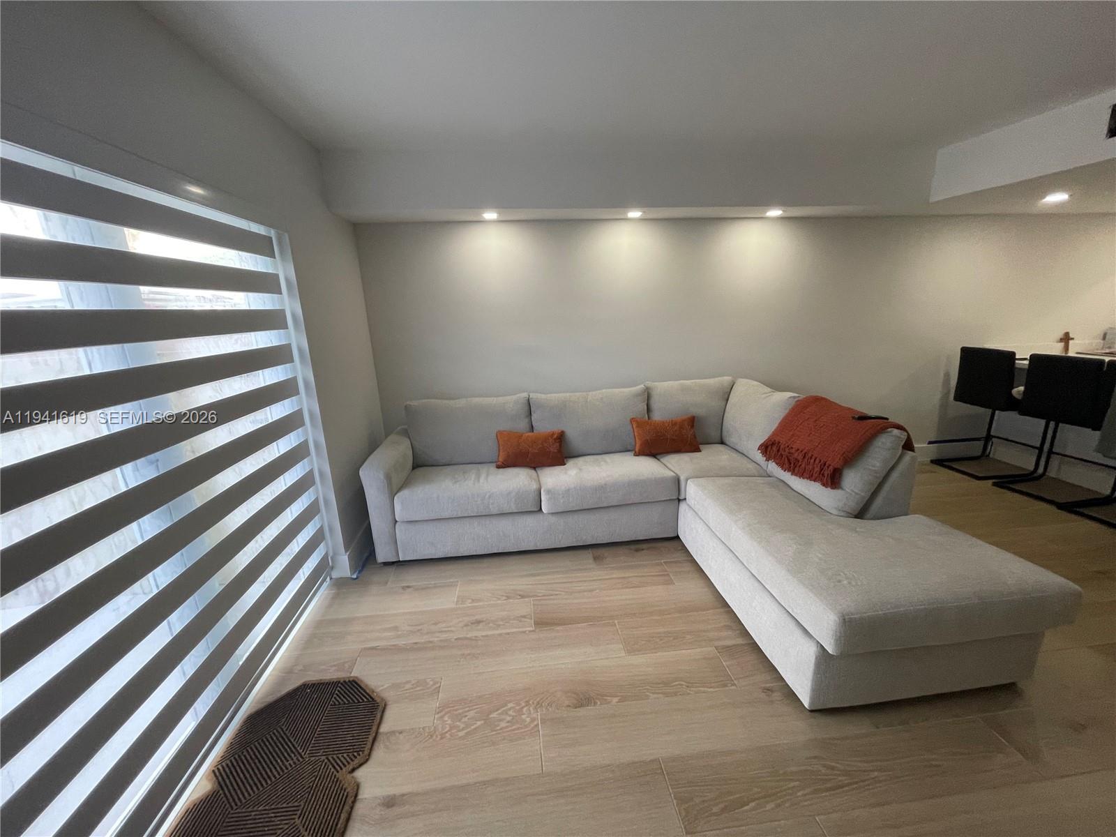 15103 Southwest 81st Street, Unit 213 Miami, FL 33193 - Photo 2 of 13 a living room with furniture and a walk in closet