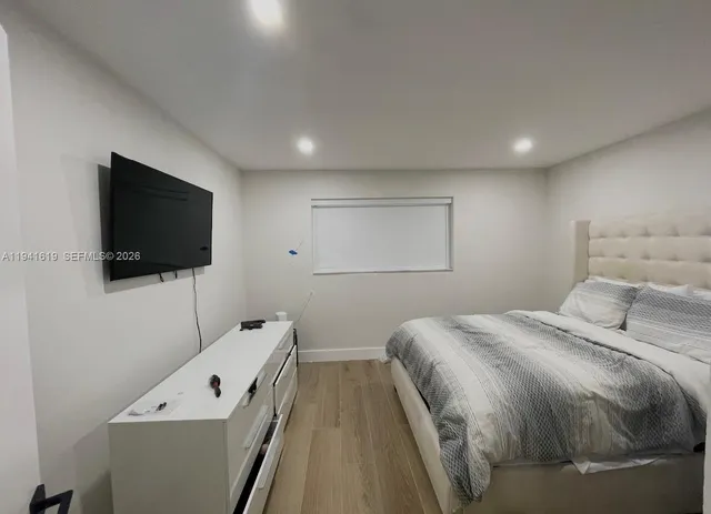 a bedroom with a bed and a flat screen tv