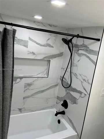 a bathroom with a glass shower door