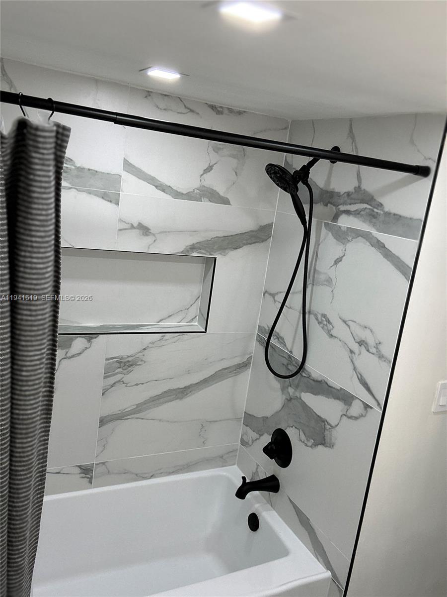 15103 Southwest 81st Street, Unit 213 Miami, FL 33193 - Photo 10 of 13 a bathroom with a glass shower door