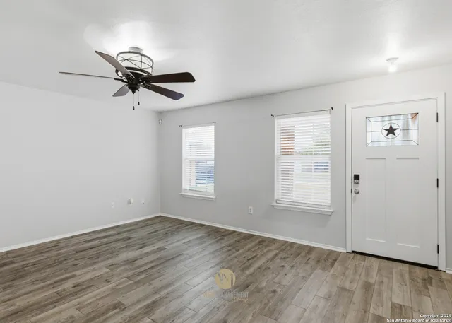 wooden floor in an empty room with a window