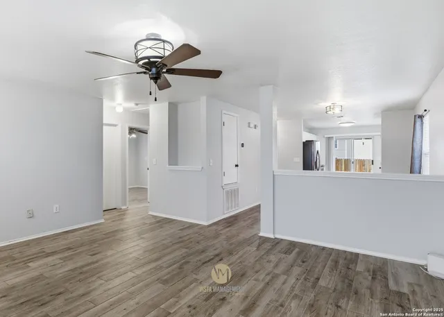 a view of empty room with wooden floor