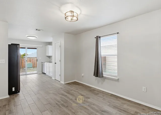 an empty room with windows and closet